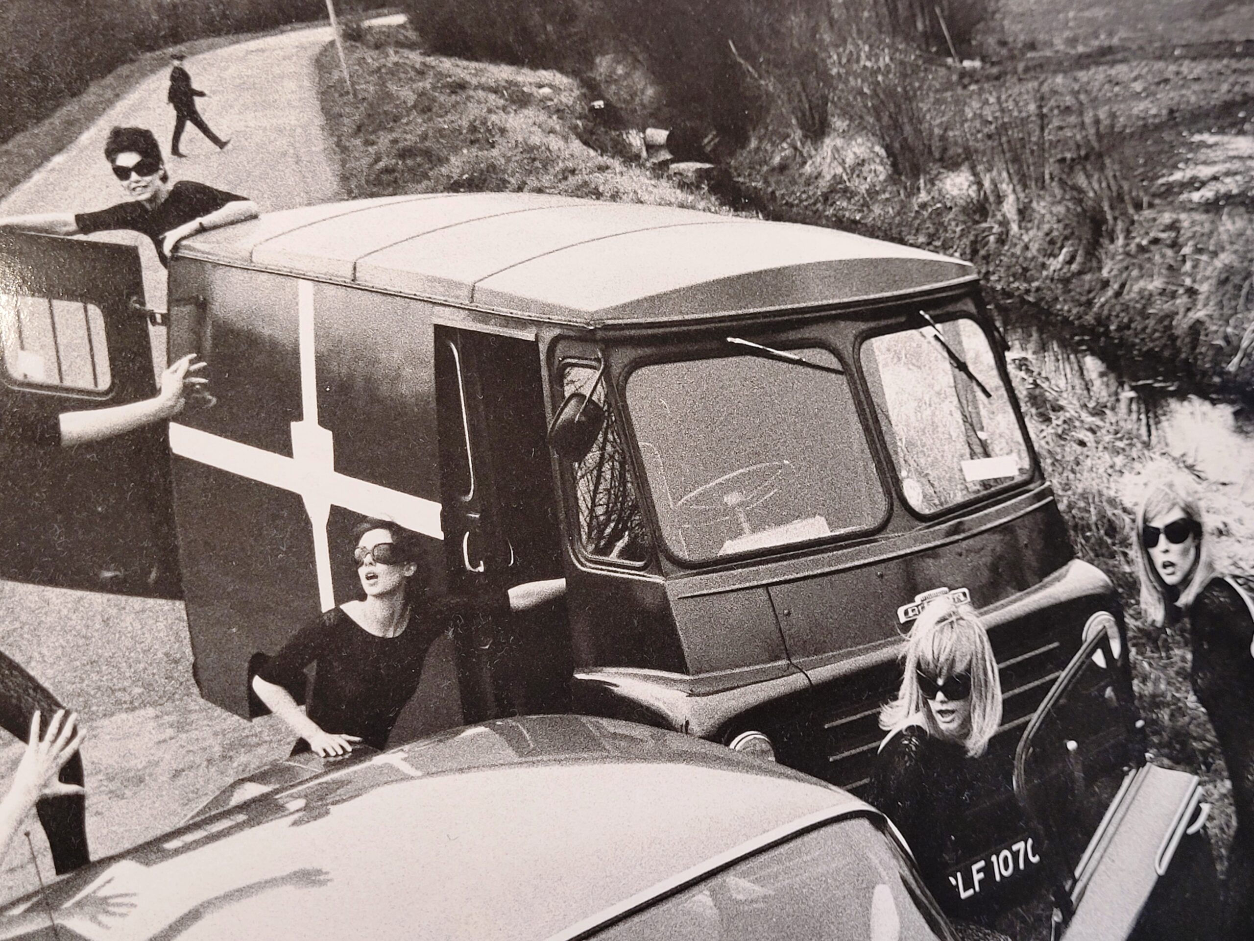 Acrilan sixties country road-block, rebellious sunglass-bearing gals and vehicles, by Michael Joseph