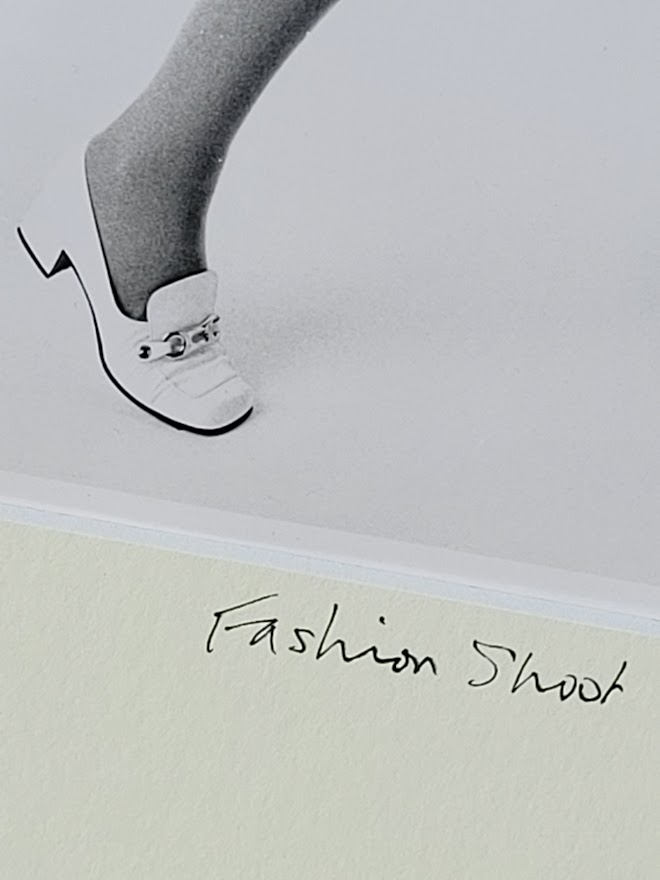 Pretty blonde model holding her glasses with her teeth, say oh really - only by Michael Joseph