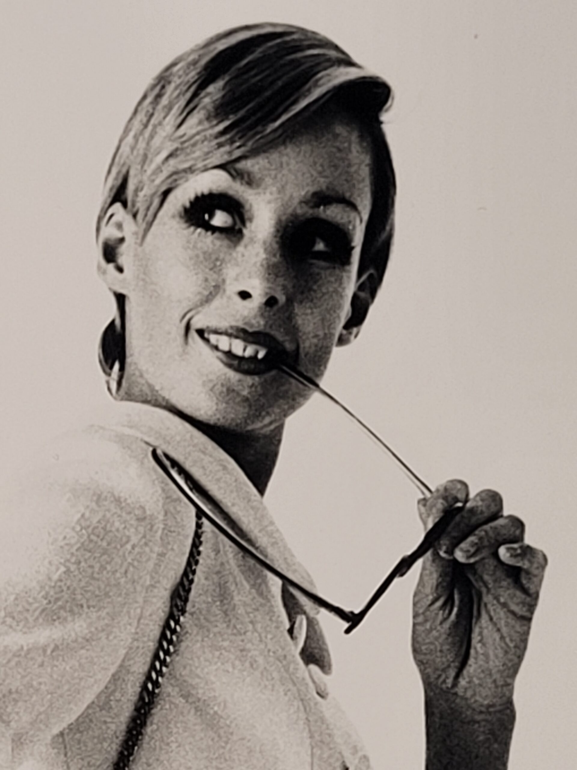 Pretty blonde model holding her glasses with her teeth, say oh really - only by Michael Joseph