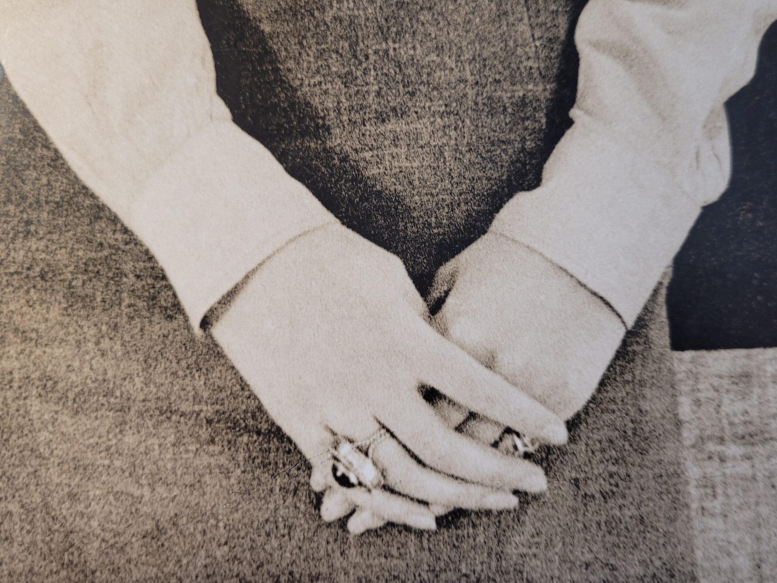 Pretty brunette with hat in front of geometric wallpaper, by Michael Joseph