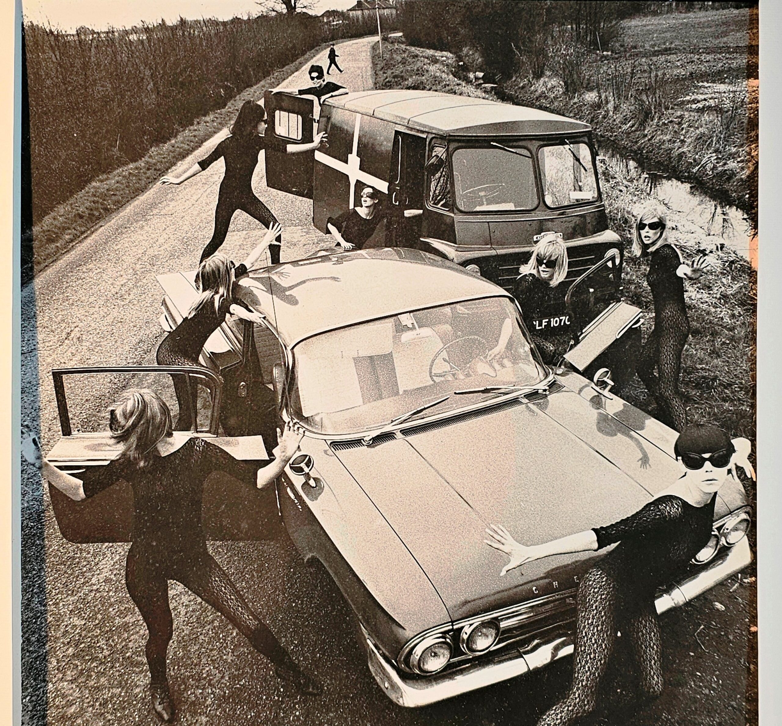 Acrilan sixties country road-block, rebellious sunglass-bearing gals and vehicles, by Michael Joseph