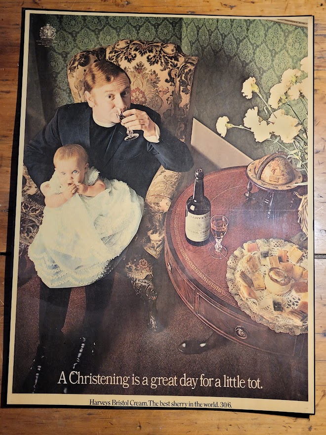 Harvey's Bristol Cream Christening Vicar holding baby great day for little tot laminated advert by Michael Joseph