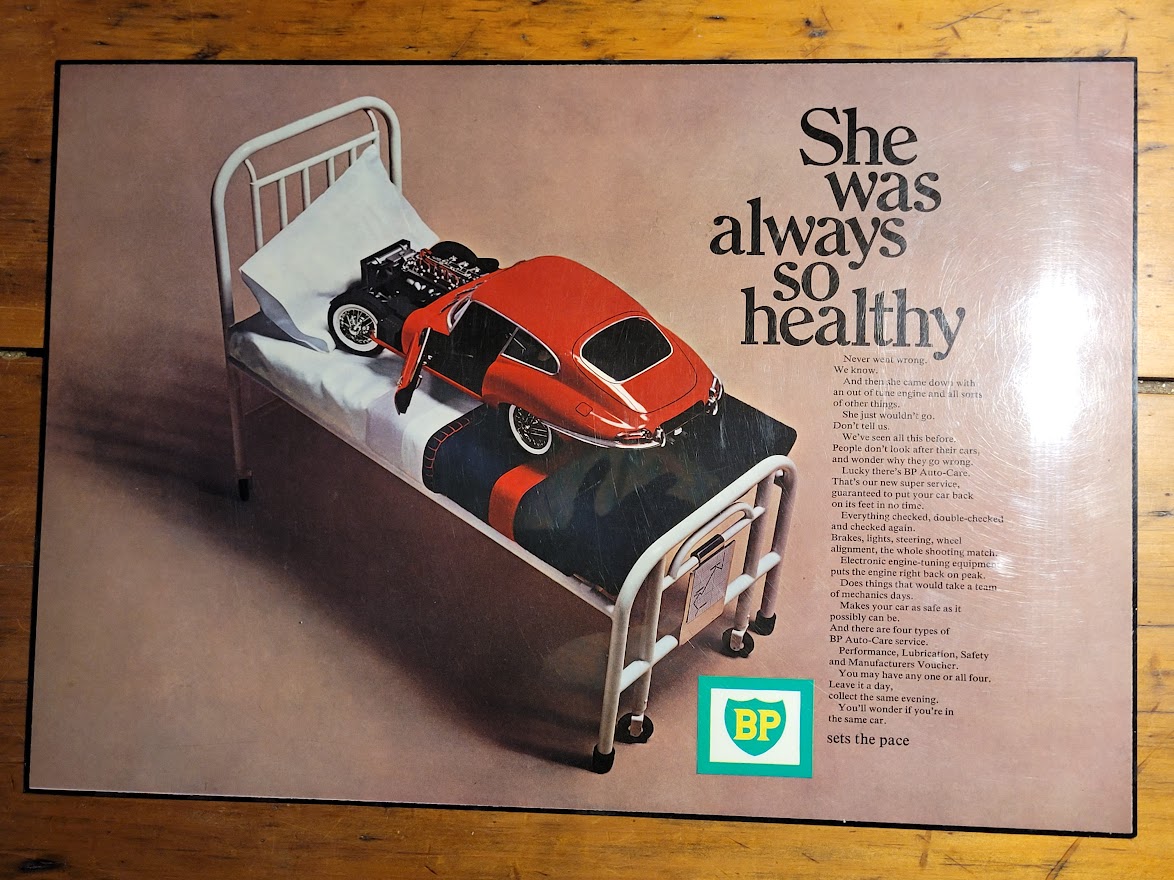 BP Red Car on hospital bed Laminated advert (by Michael Joseph)