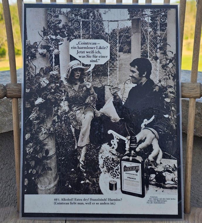 Couple drinking in rose garden, harmless liqueur Cointreau, ad by Michael Joseph